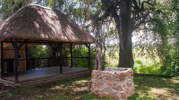 Campsite 3 with a thatched shelter and deck